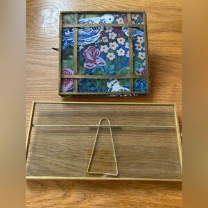 Anthropologie brass and glass pane frame and a glass and gold rectangle frame.